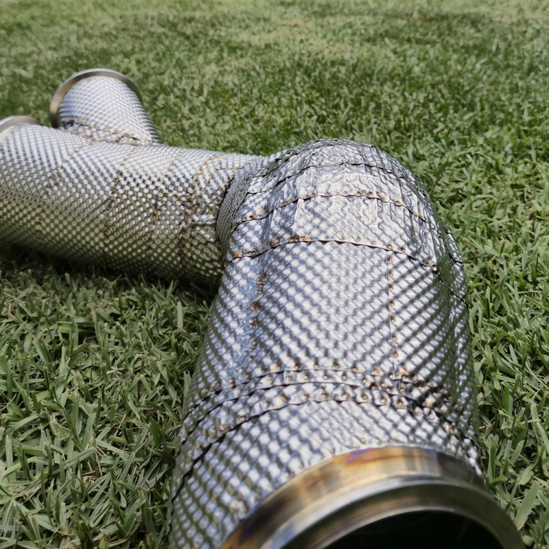 Completed multi-layer thermal shield on a complex exhaust Y-pipe section.