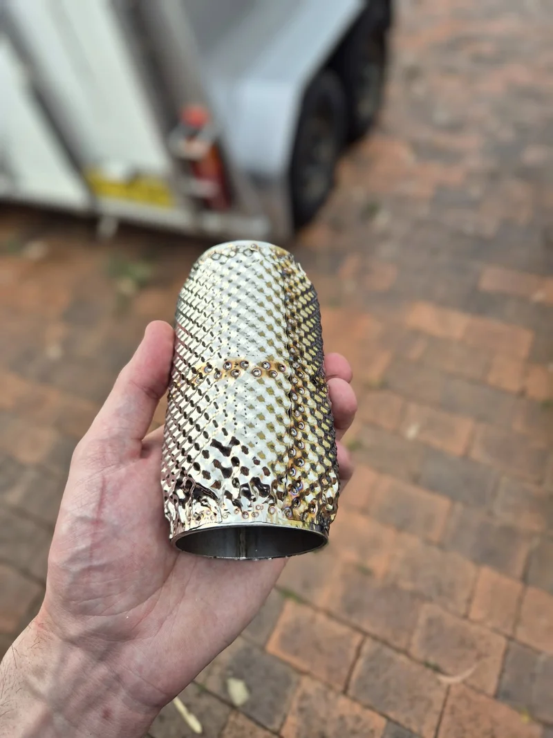 Custom-fabricated embossed 304 stainless steel heat shield test section for exhaust thermal management in motorsport applications.